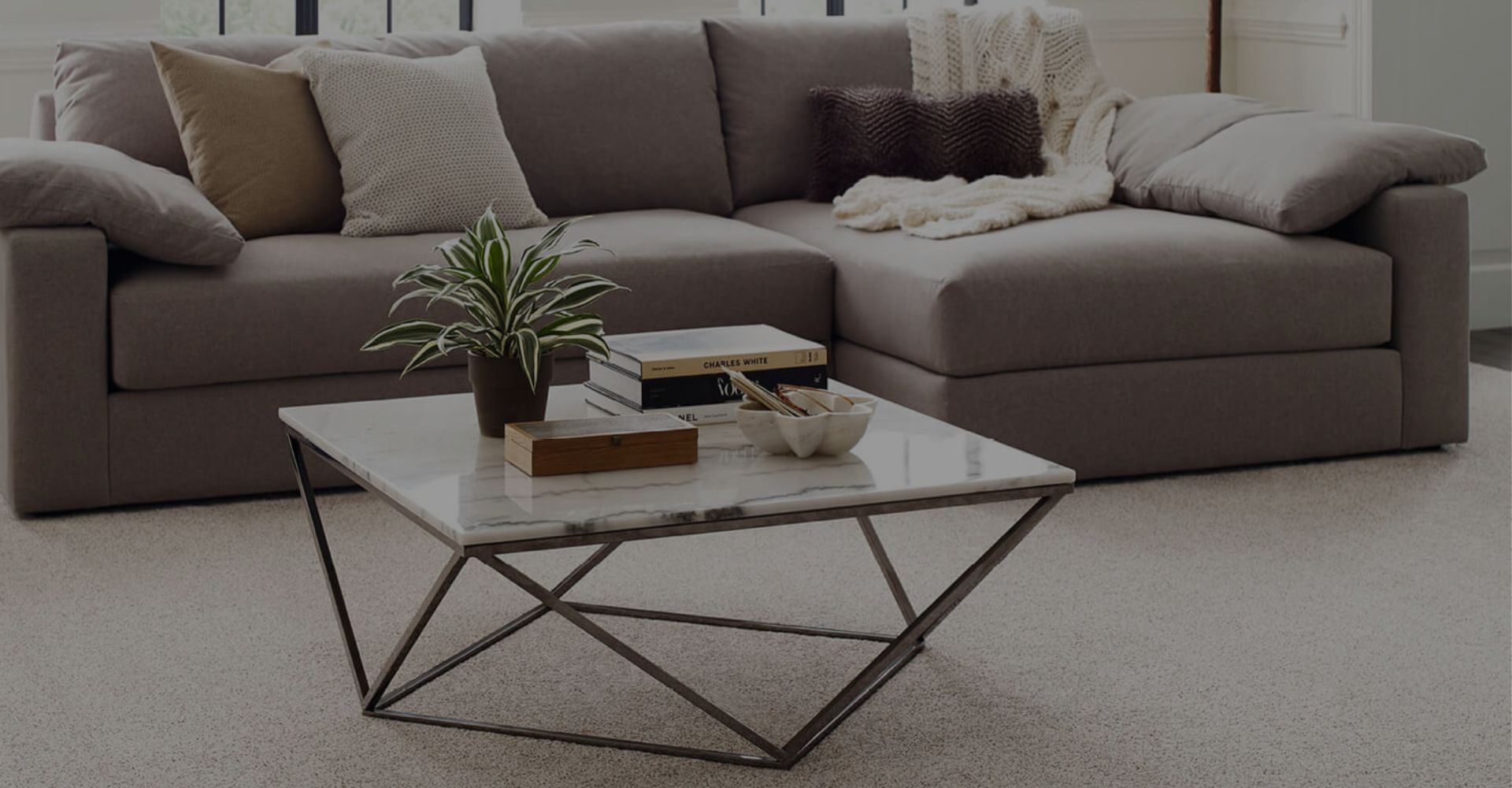 Woman sitting on a hardwood floor with a coffee mug in her hand.